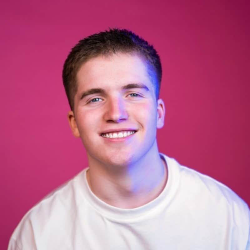 Marketing professional smiling against vibrant magenta background