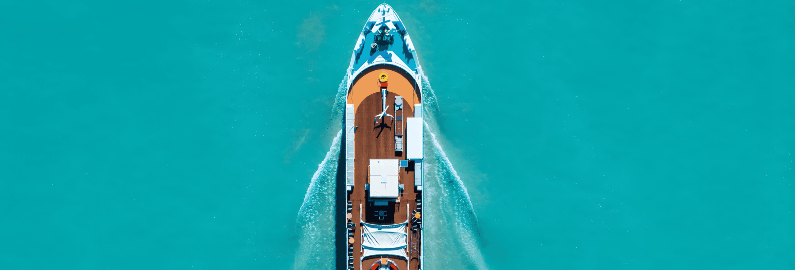 Luxury speedboat aerial view on turquoise water with white wake