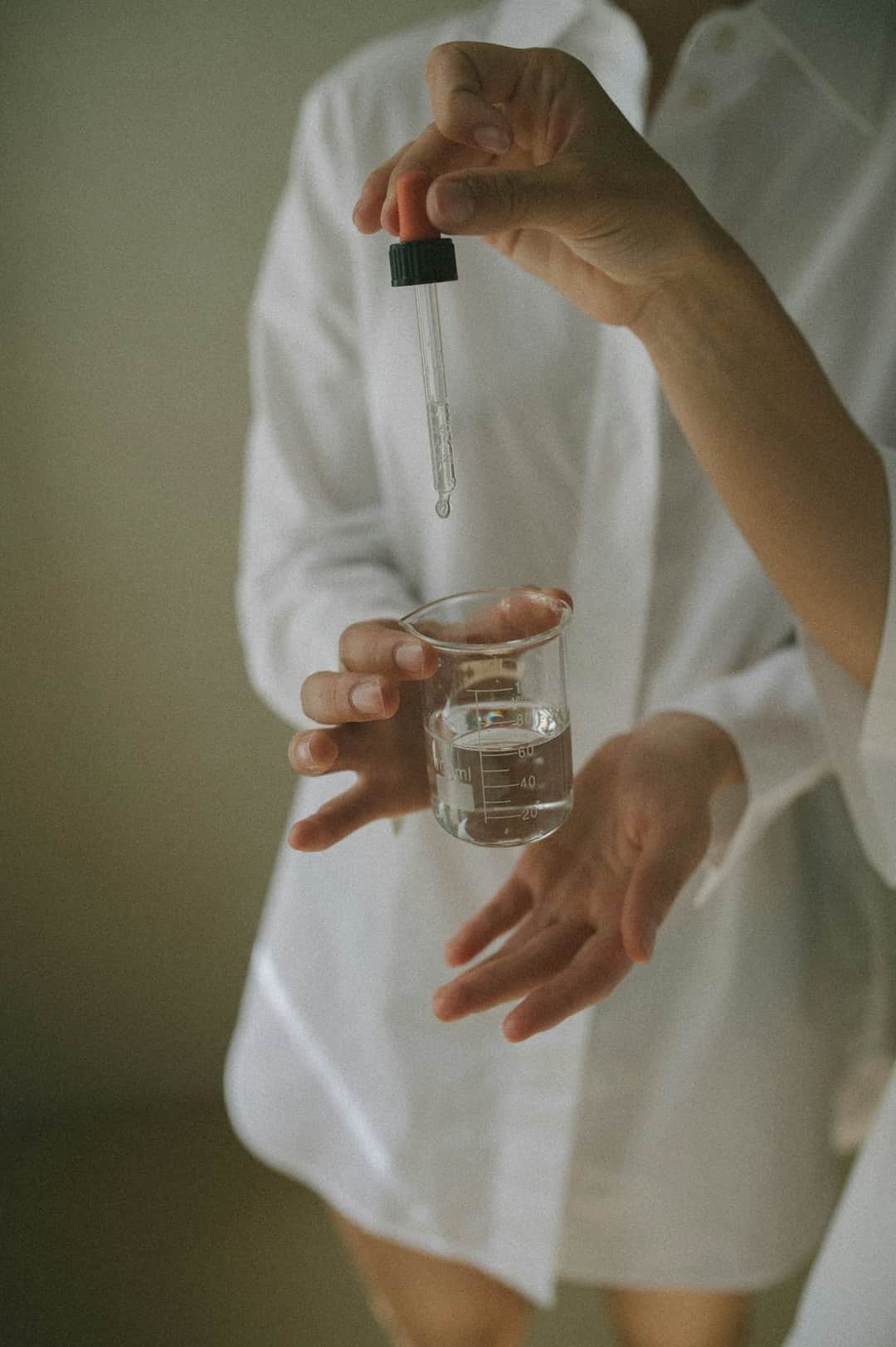 Online doctor with prescription dropper bottle and water for medication