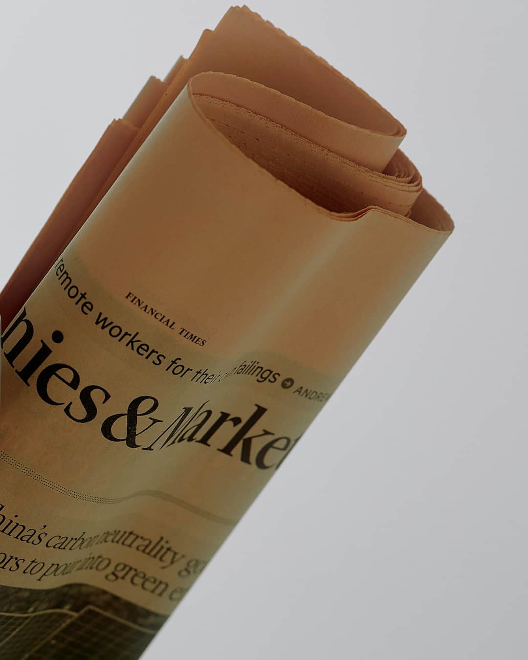 Rolled Financial Times newspapers featuring business and markets articles