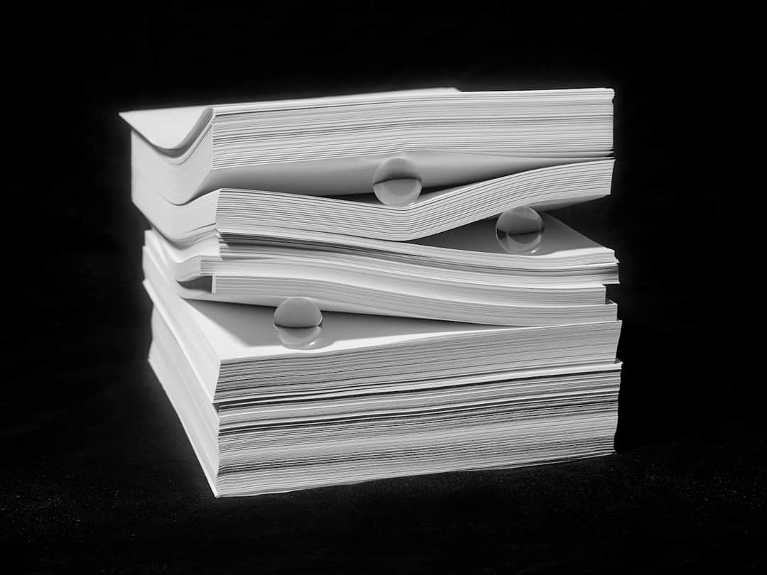 Stacked open books with water droplets symbolizing knowledge of search algorithm updates