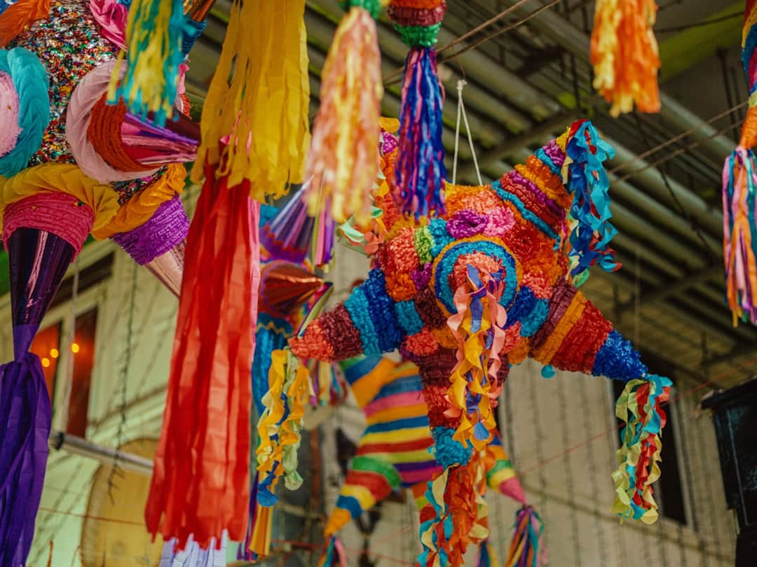 Colorful hanging piñatas at Manchester Design Festival installation