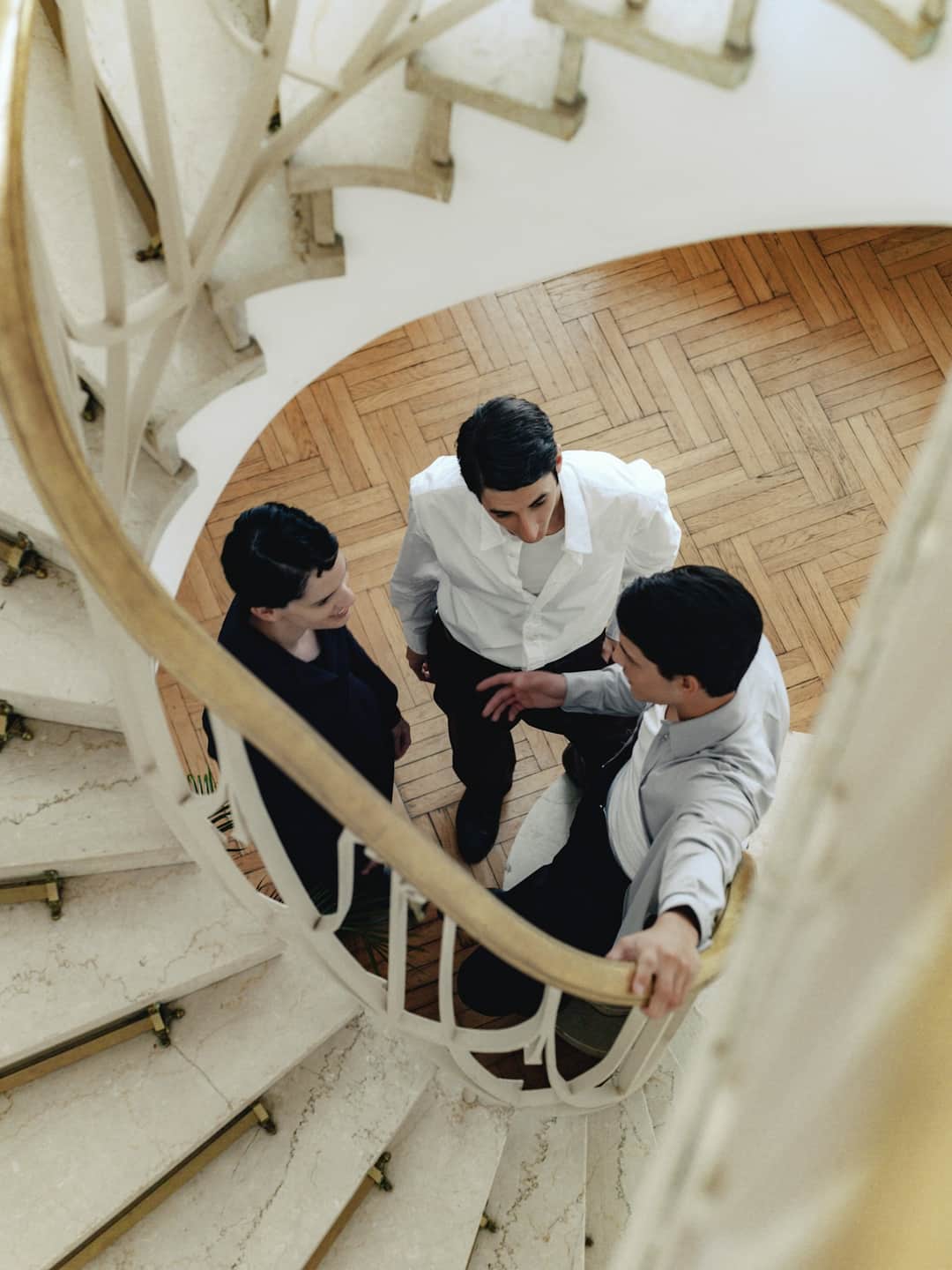 Business professionals collaborating on marketing strategy in an office stairwell