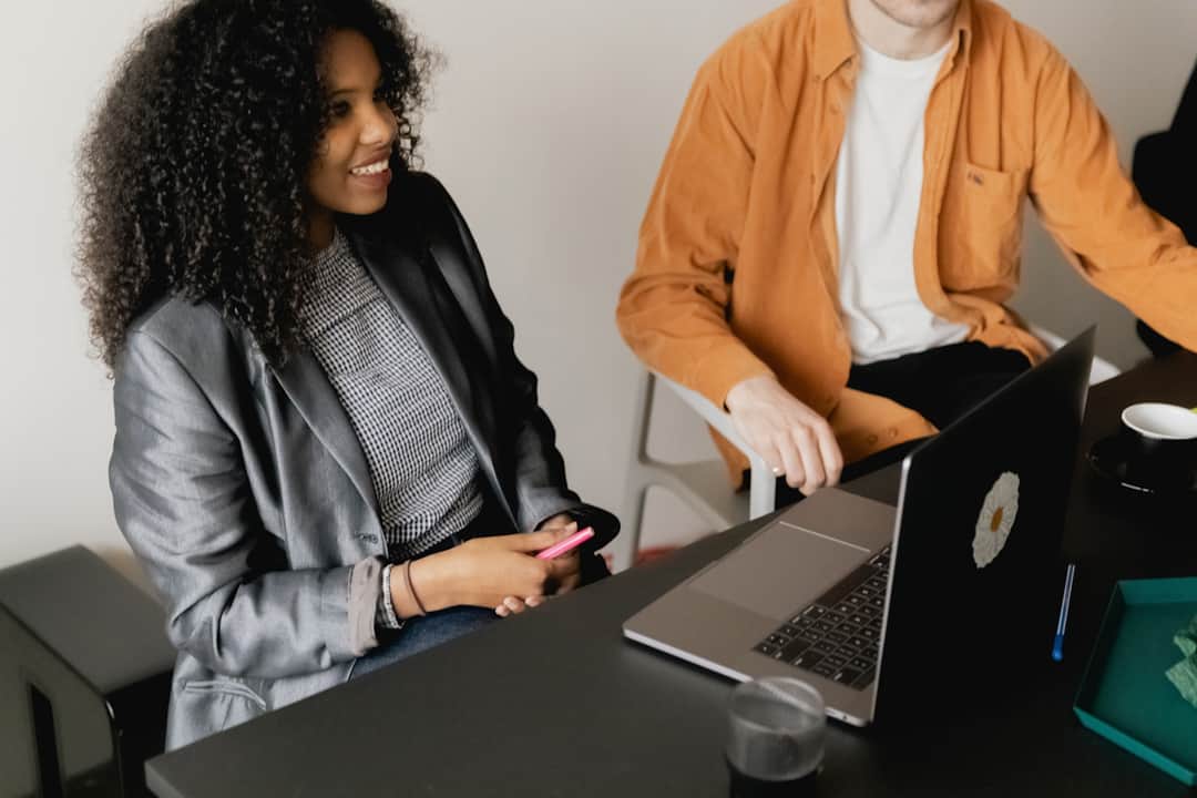 Two marketing professionals collaborating on digital strategy at a desk