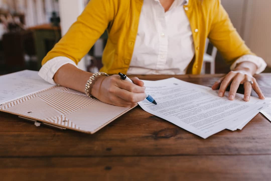 Home buyer signing mortgage documents at desk