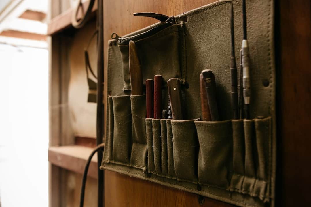 Canvas tool apron with organized woodworking hand tools and chisels