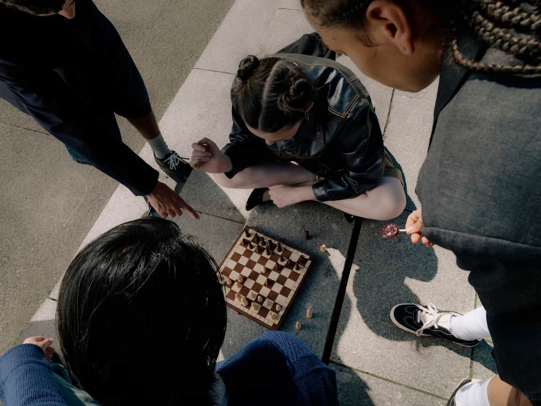Competitors playing chess from overhead view, representing strategic analysis