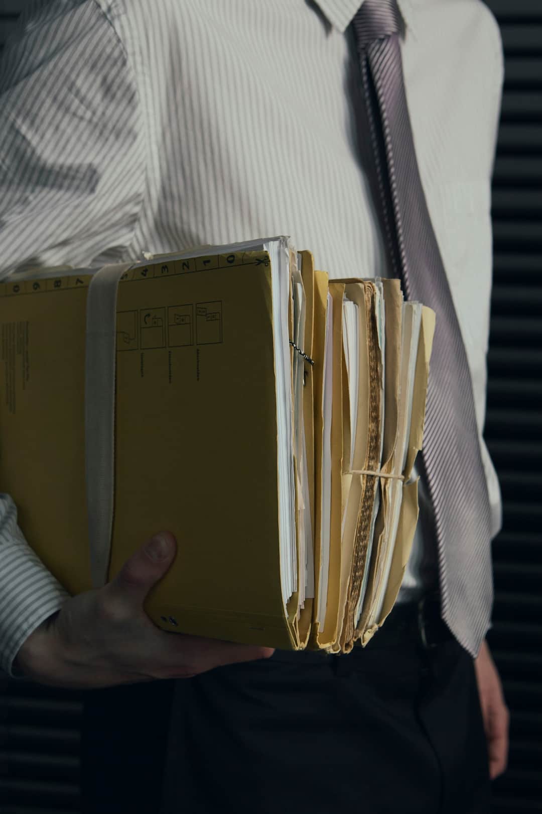 Business professional organizing documents in notebook for Google disavow file audit