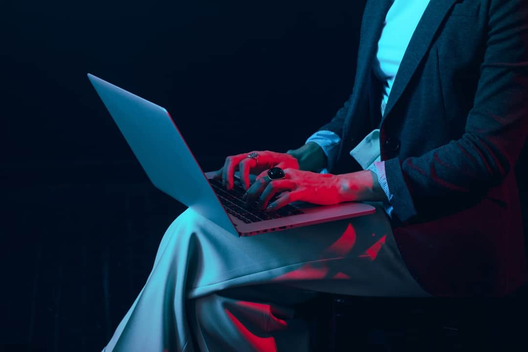 Professional hands on laptop with neon AI lighting for PPC marketing