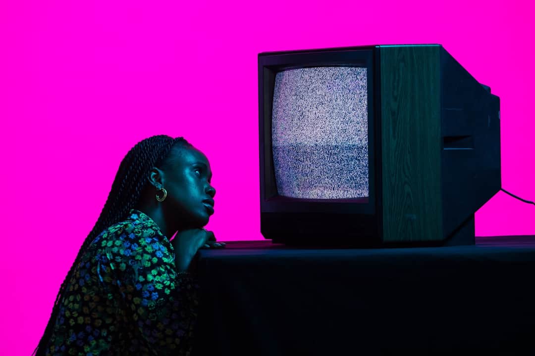Woman gazing at television static representing unclear brand signals