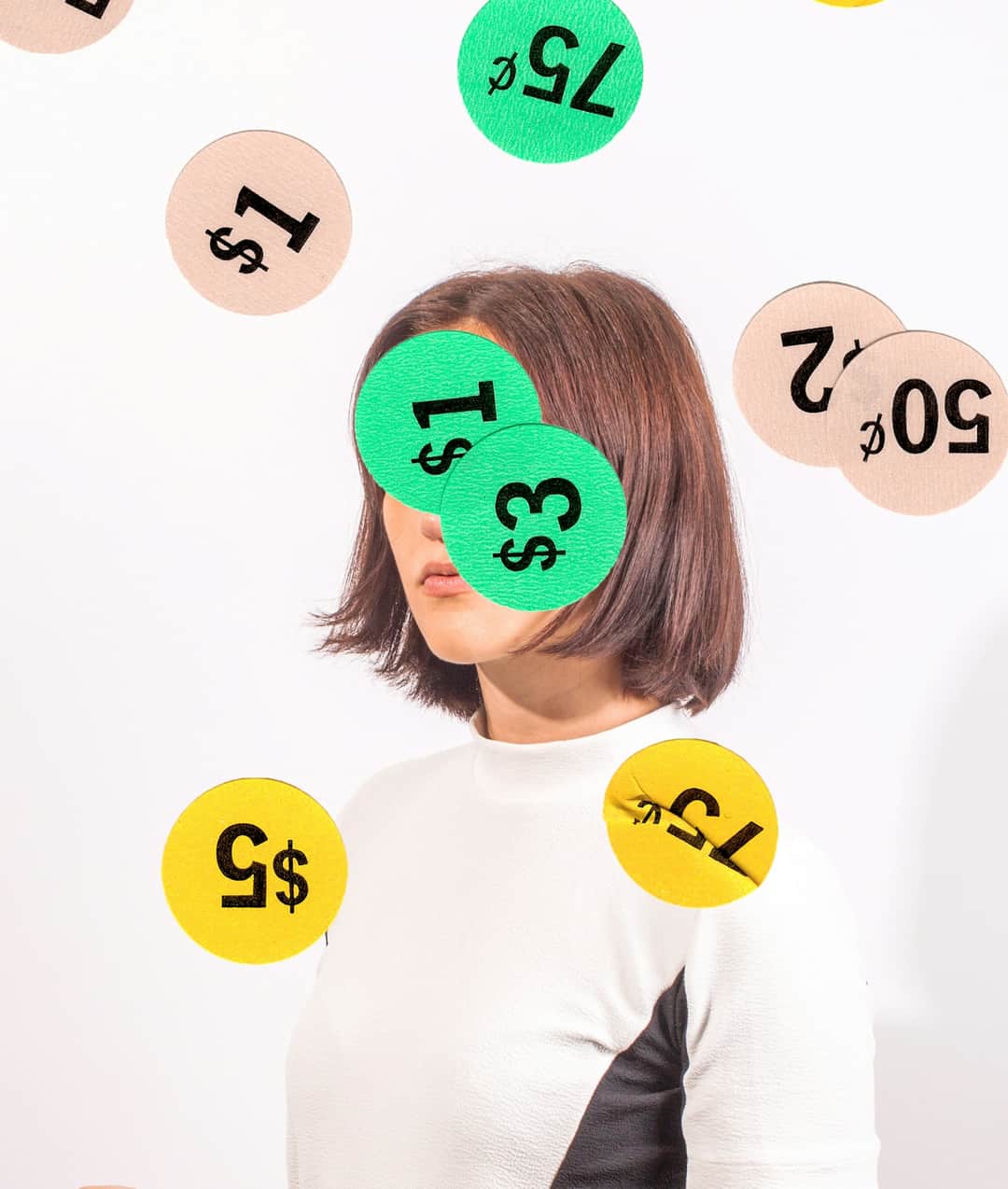 Woman covered by floating dollar amount circles, illustrating PPC campaign tracking and costs