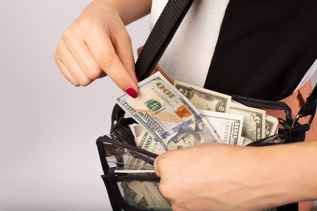 Wallet overflowing with dollar bills symbolizing revenue growth from PPC optimization
