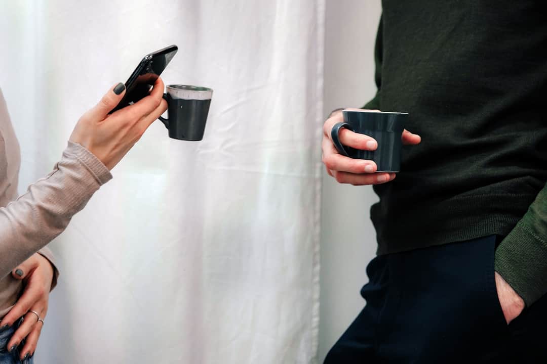 Two consumers with smartphones and coffee in a modern lifestyle mood board