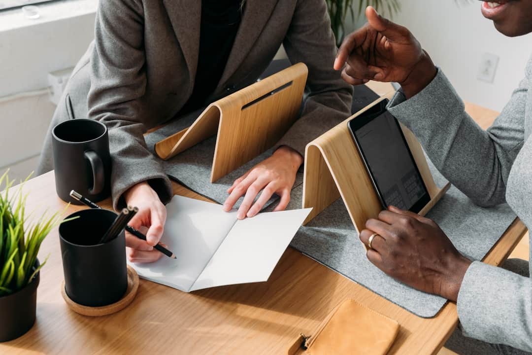 Marketing professionals analyze PPC campaign profit metrics and strategy together