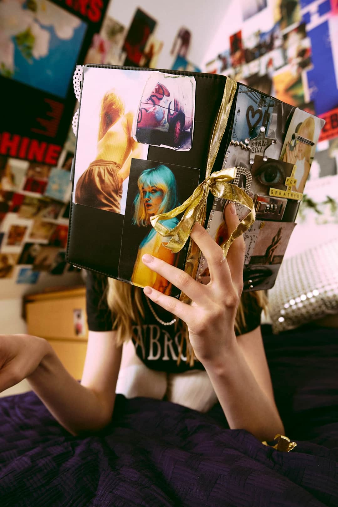 Hands holding open personalised photo magazine with collaged images