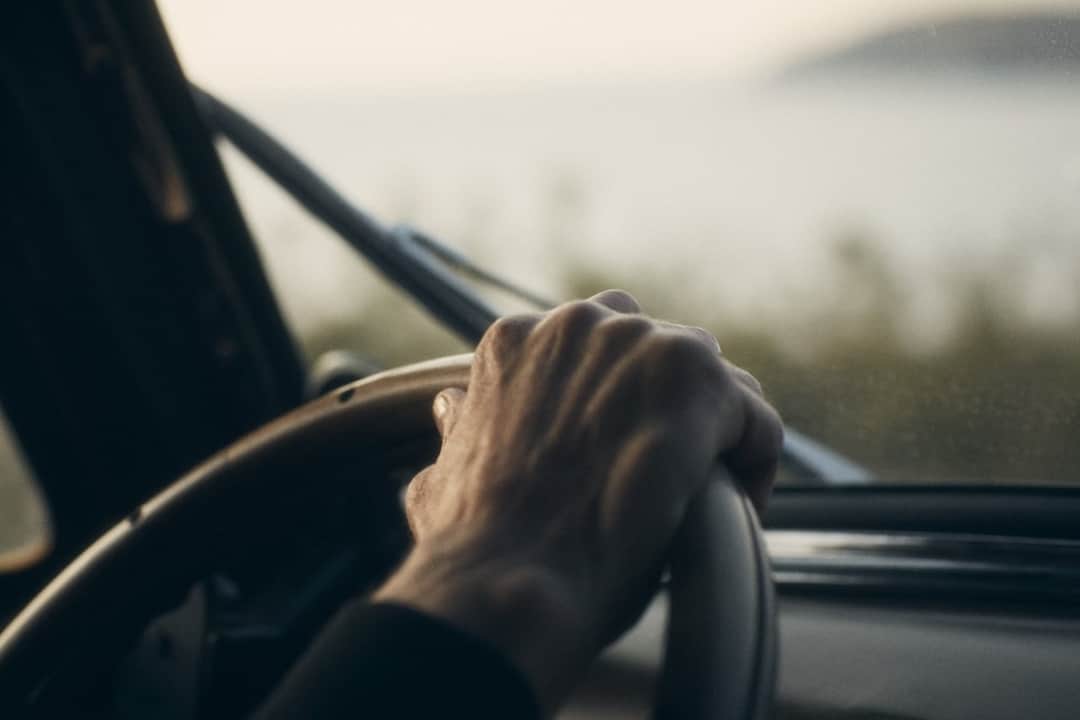 Hands gripping steering wheel with determined focus and control