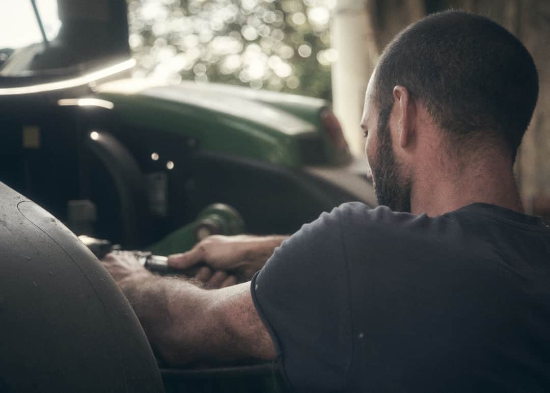 Driver gripping steering wheel in car interior