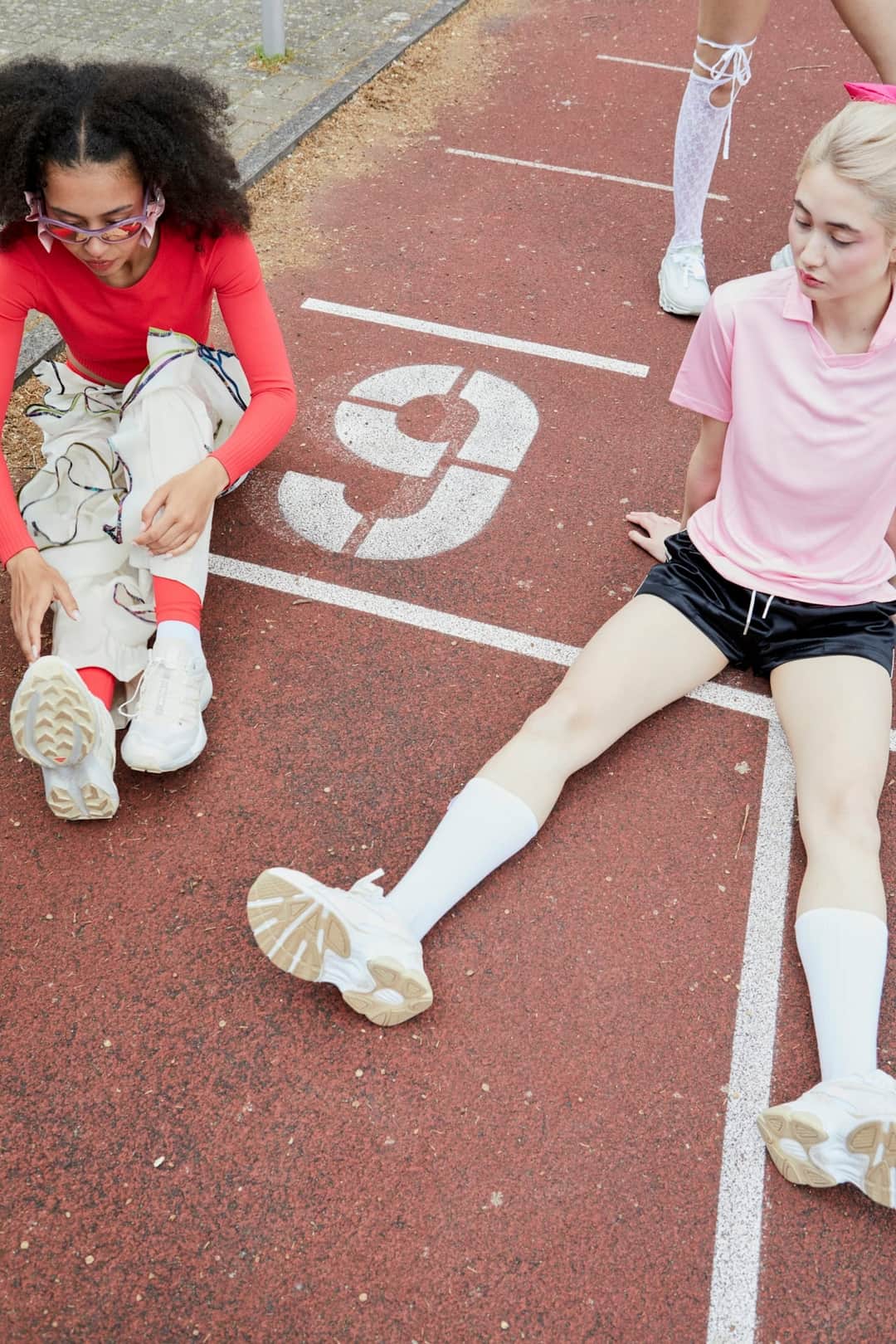 Runners taking a break on athletic track during training session