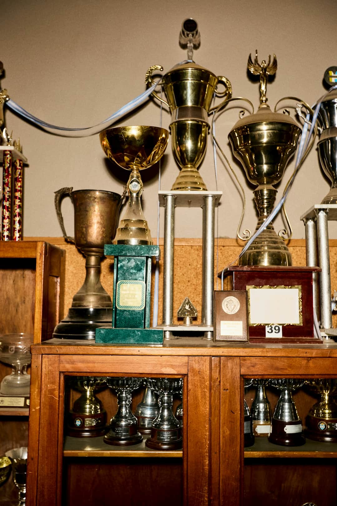 Trophy collection of gold and silver awards on wooden shelves symbolizing campaign success