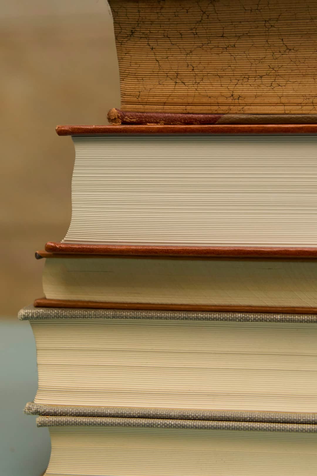 Stack of reference books representing sector reports and research