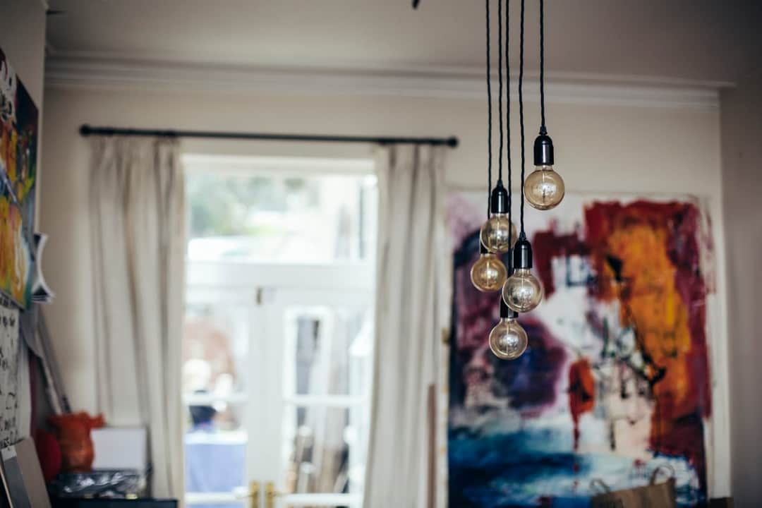 Contemporary interior with hanging glass pendant lights and abstract wall artwork