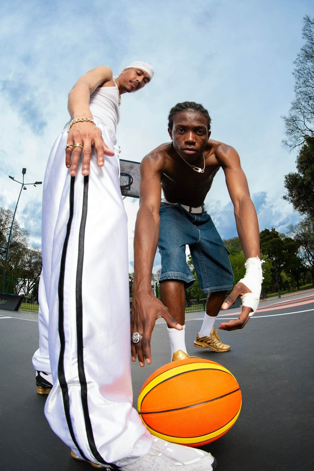 Two athletes with basketball and towel on court, embodying sustainable organic growth through teamwork