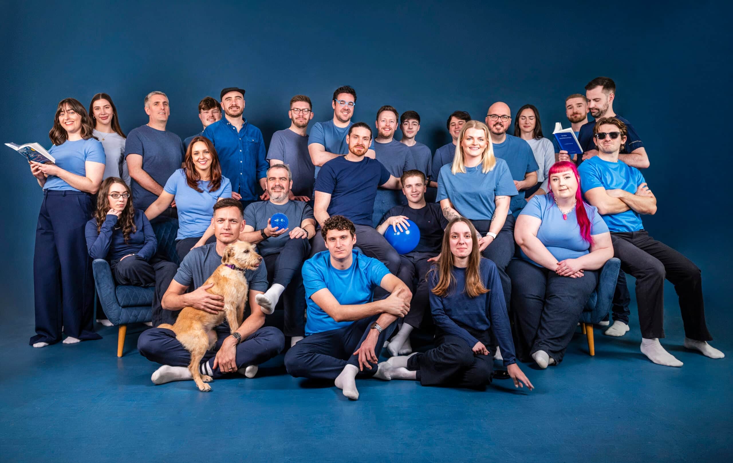 Salience ecommerce agency team members in blue clothing against studio background