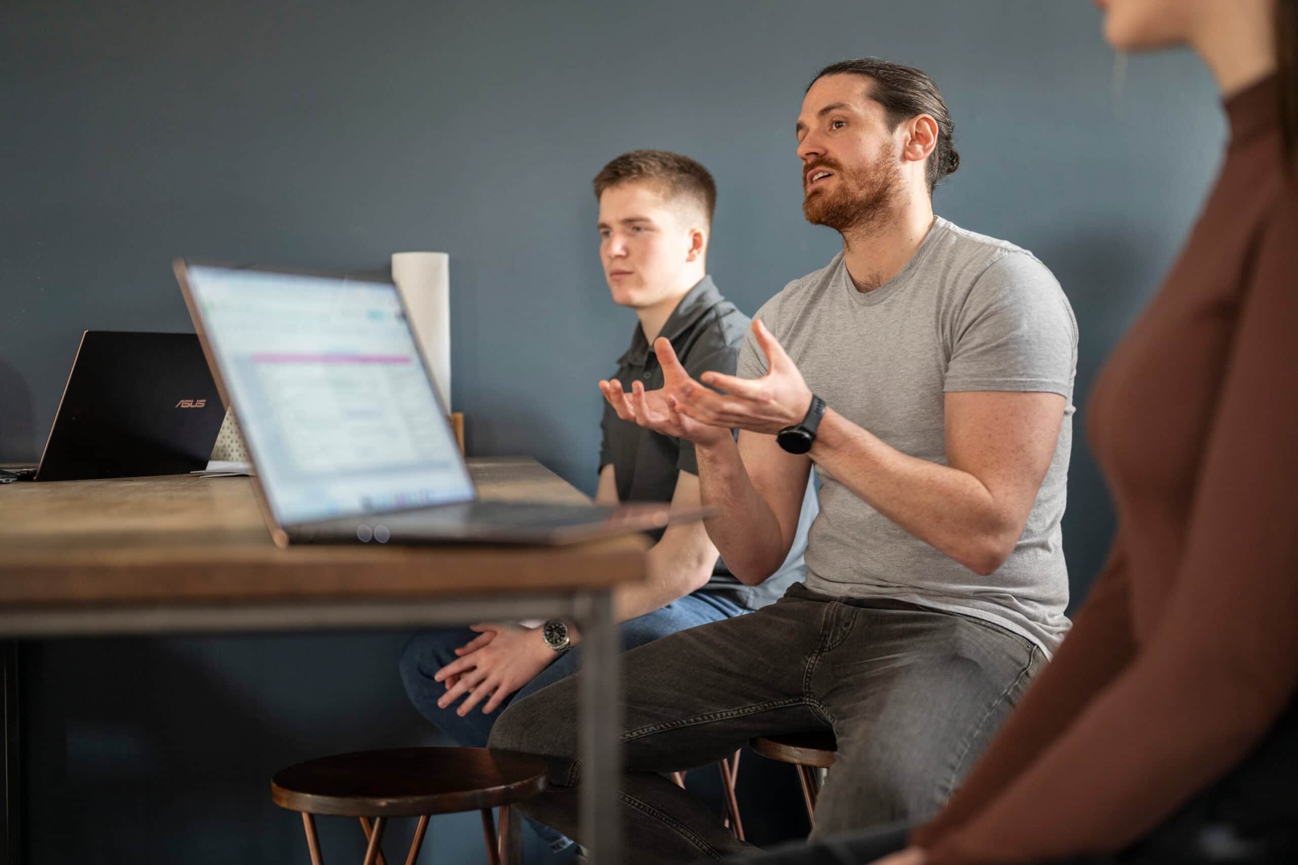 Team members in a meeting discussing marketing strategies at Salience agency.