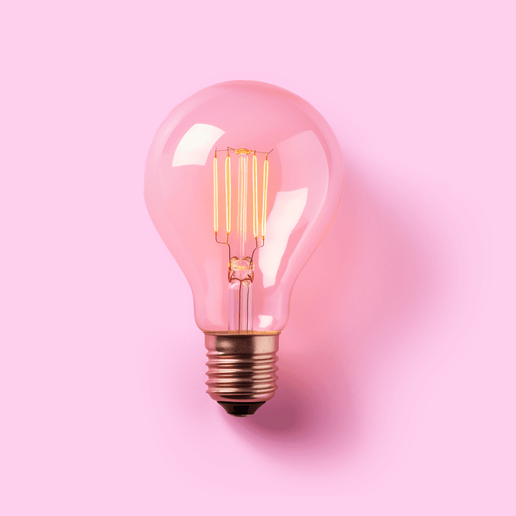 Pink light bulb on pink background representing energy concept in Salience's study on UK energy companies' popularity.
