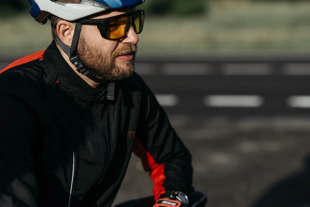 Side profile of a cyclist wearing protective gear and sunglasses on a sunny day. (Photo: Pavel Danilyuk via Pexels)