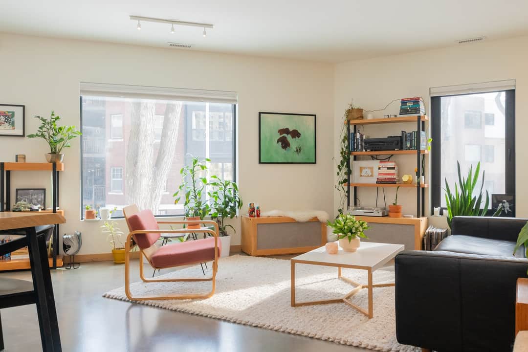 Modern living room with minimalist decor, indoor plants, and neutral tones.