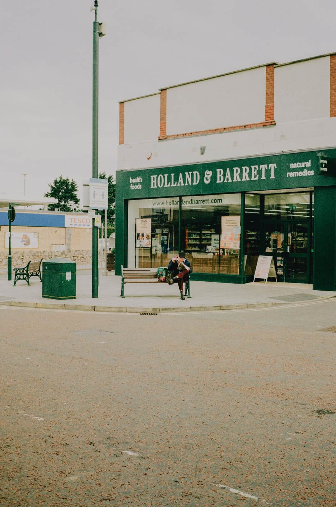 Street view of Holland & Barrett store, featuring urban architecture and sidewalks on a cloudy day. (Photo: Lisa from Pexels via Pexels)