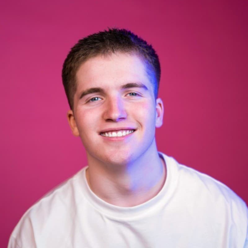 Marketing professional smiling against vibrant magenta background