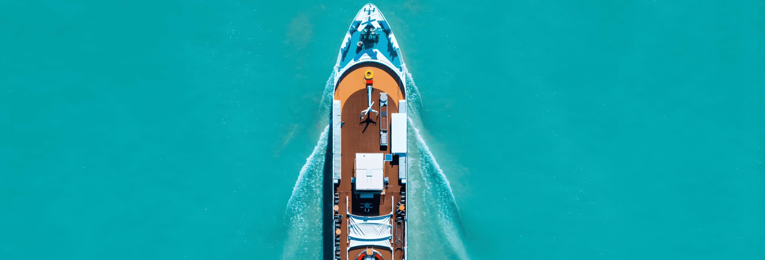 Luxury speedboat aerial view on turquoise water with white wake