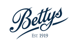Bettys vintage tea house logo in navy script with EST. 1919 establishment date