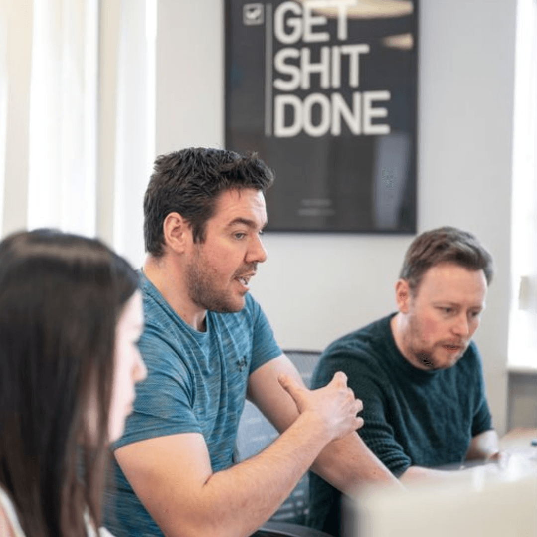 Three professionals collaborating on business growth strategy in meeting