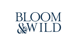 Bloom Wild logo featuring navy serif typography with decorative botanical elements