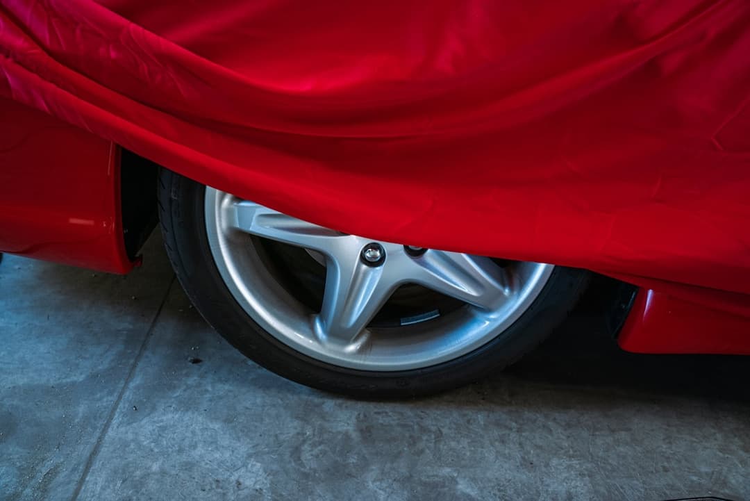 Red car wheel with metallic alloy rim design