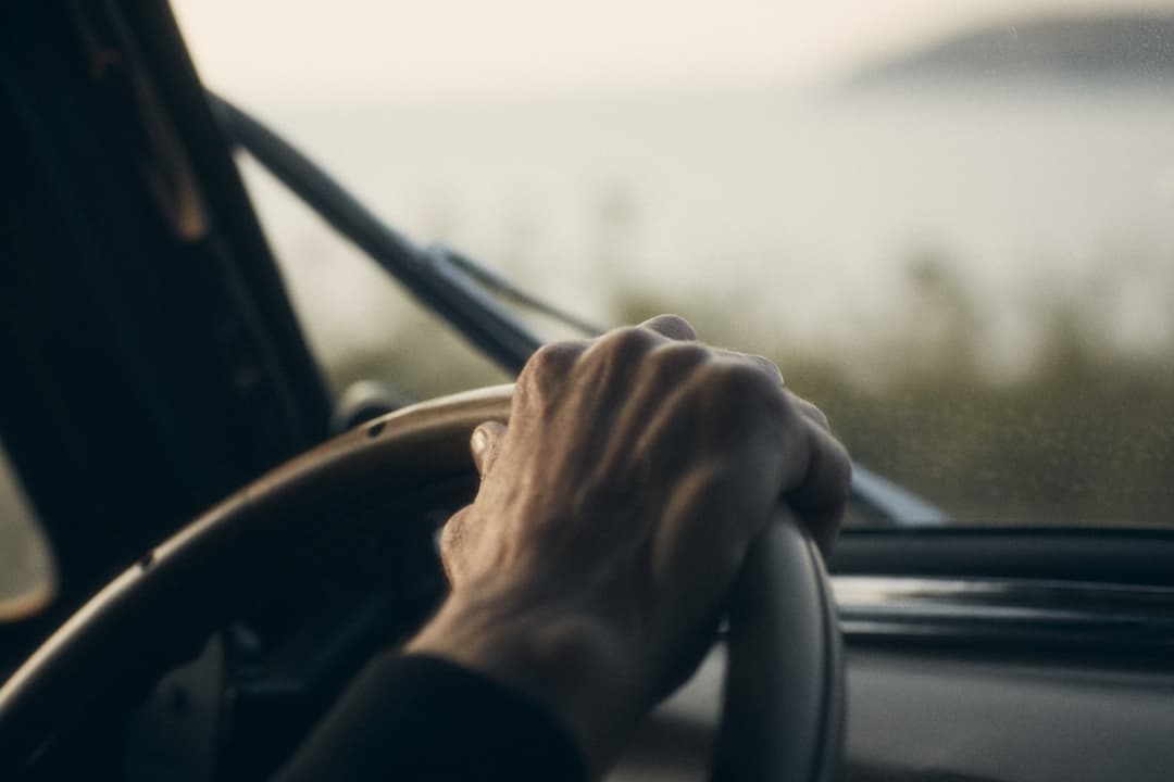 Hands gripping steering wheel with determined focus and control