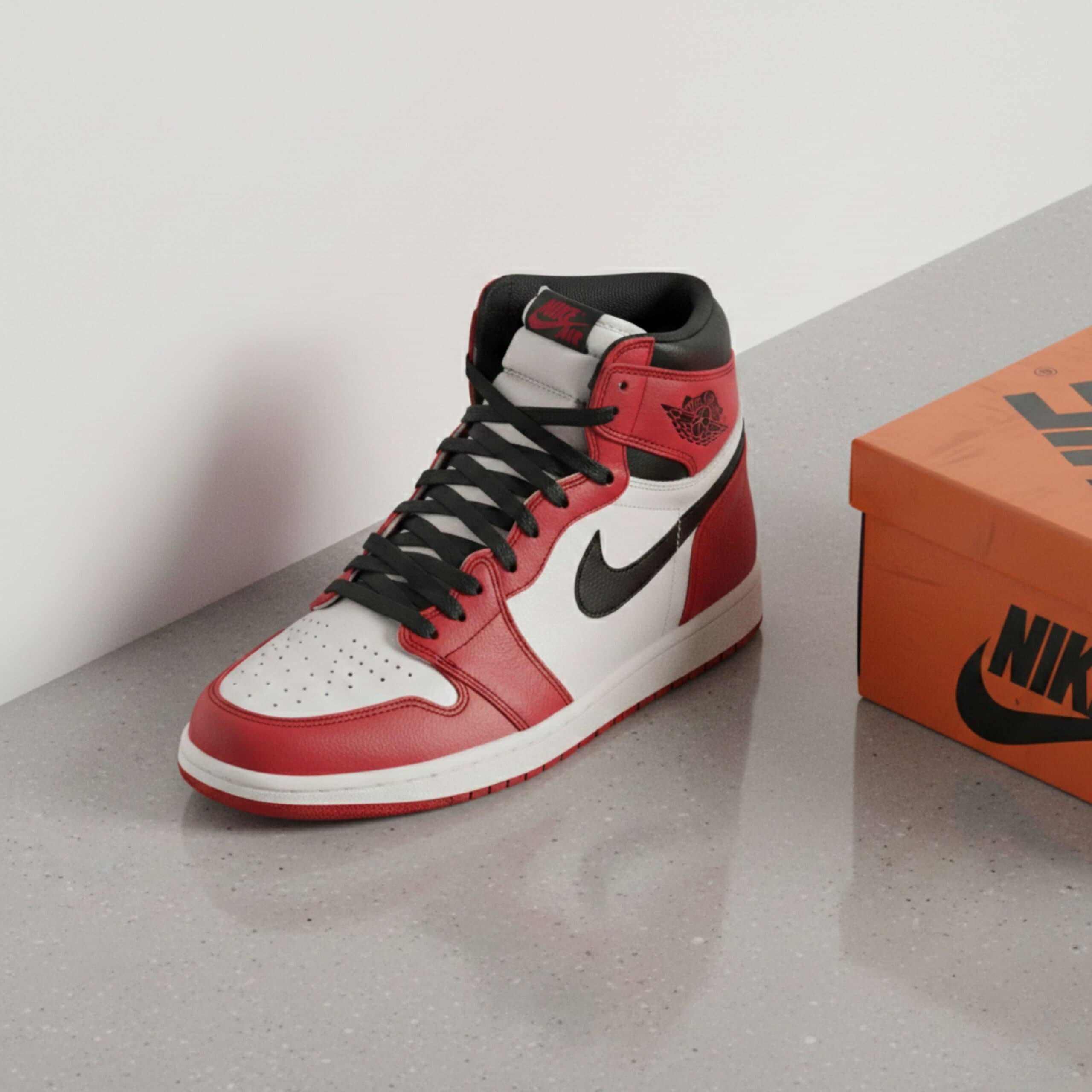 Nike Air Jordan 1 sneaker in red, white, and black with box on gray surface.