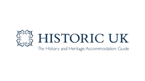 Historic UK heritage accommodation guide logo with blue decorative shield emblem