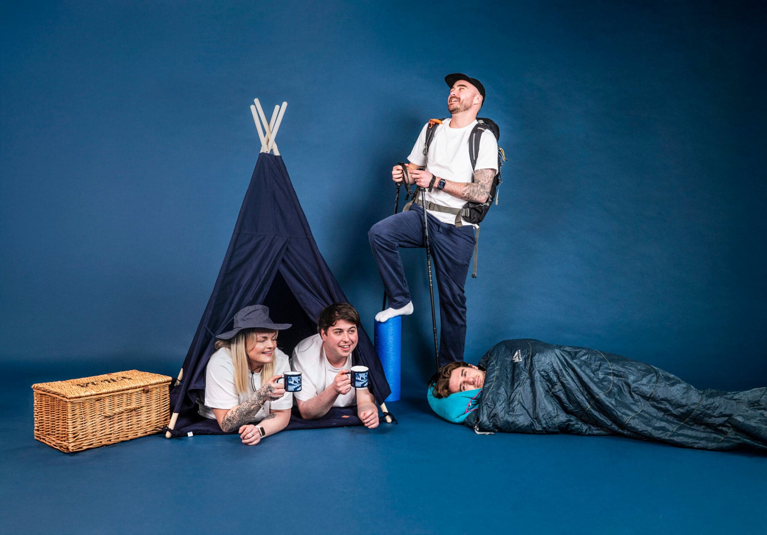 Ecommerce agency team posing with camping props in studio