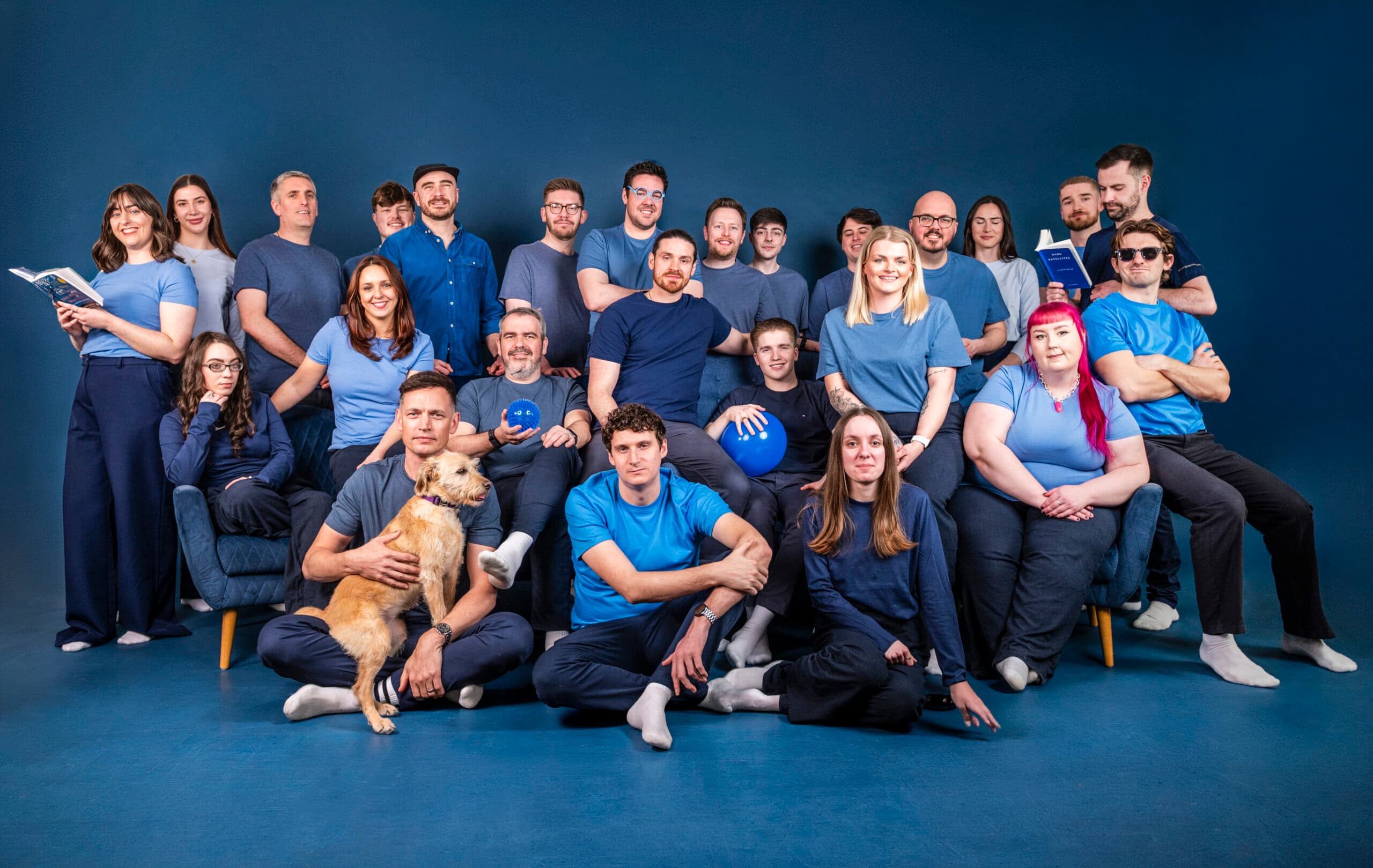 Salience ecommerce agency team members in blue clothing against studio background