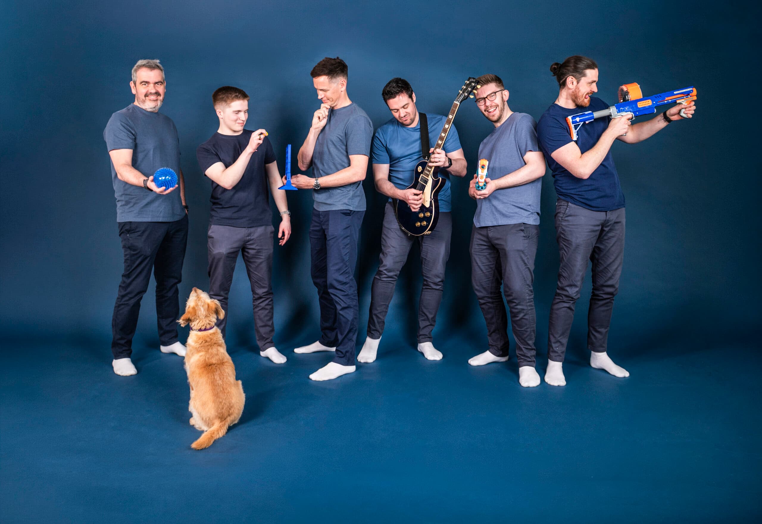 E-commerce agency team of six with toy guns and golden dog