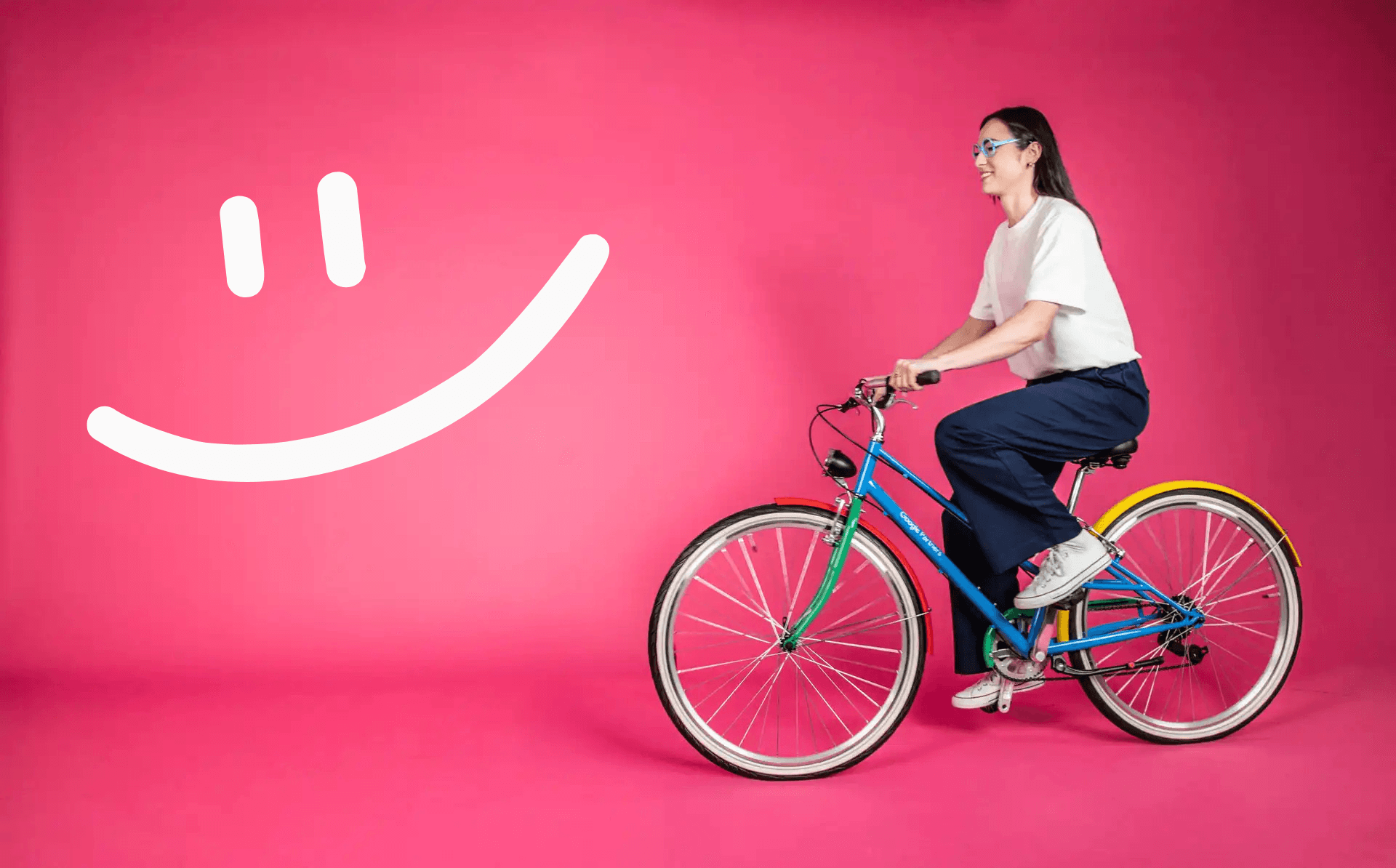 Smiling cyclist on colorful bike against pink background representing e-commerce business growth