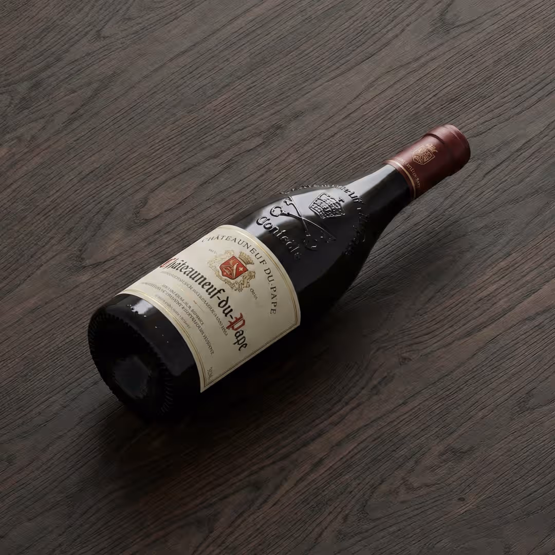 ChΓ’teauneuf-du-Pape wine bottle on wooden surface.
