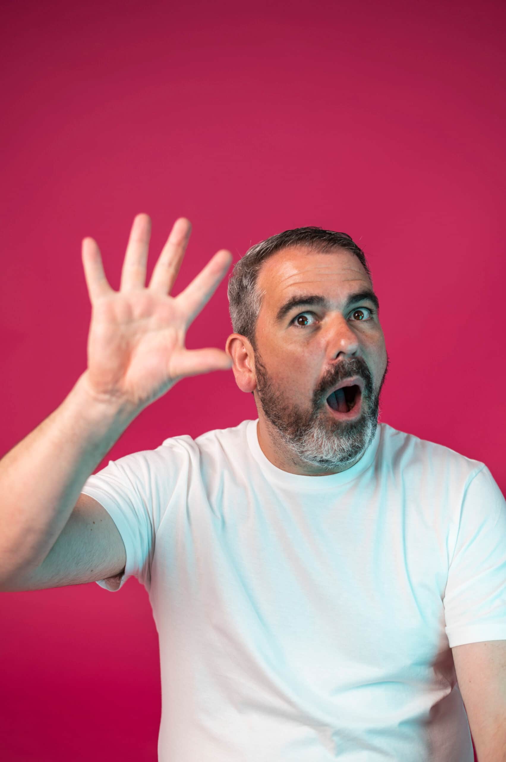 Marketing team member portrait with animated hand gesture on pink background
