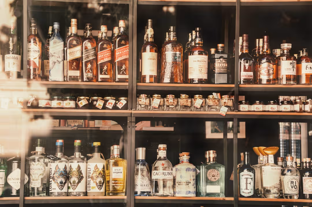 A diverse selection of liquor bottles elegantly displayed on shelves in Valletta, Malta. (Photo: Danny Doneo via Pexels)