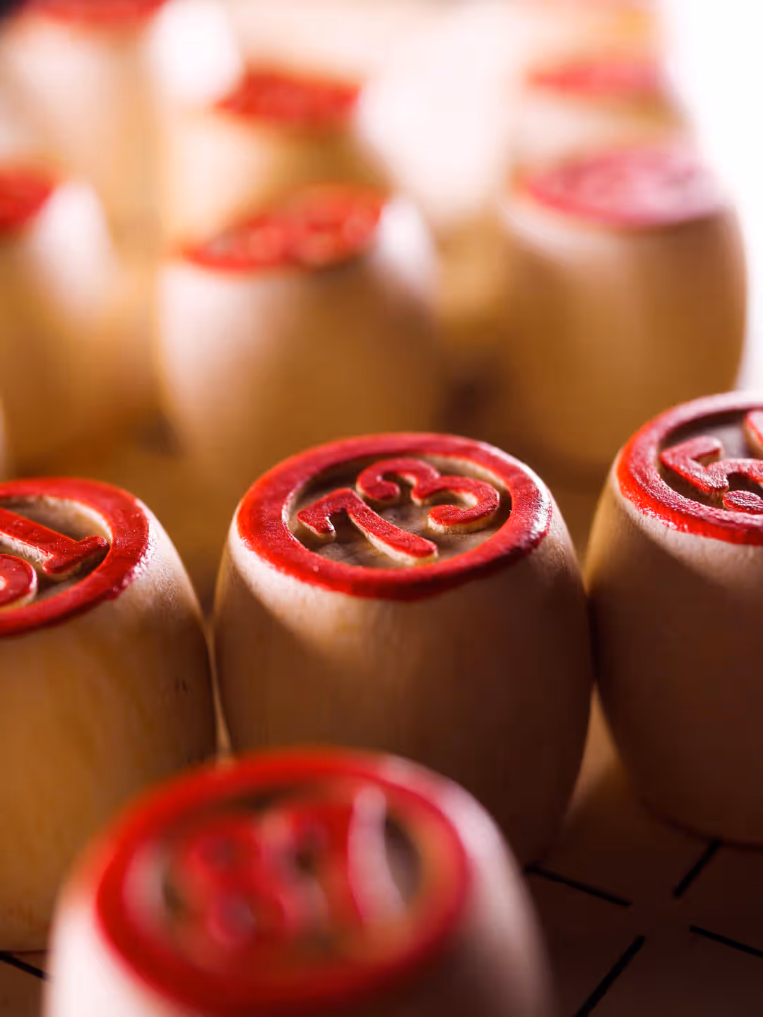 Wooden bingo pieces with red numbers create a nostalgic gaming feel. (Photo: RĹŤdolfs Klintsons via Pexels)